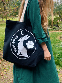 black canvas tote bag with rose and ravine logo