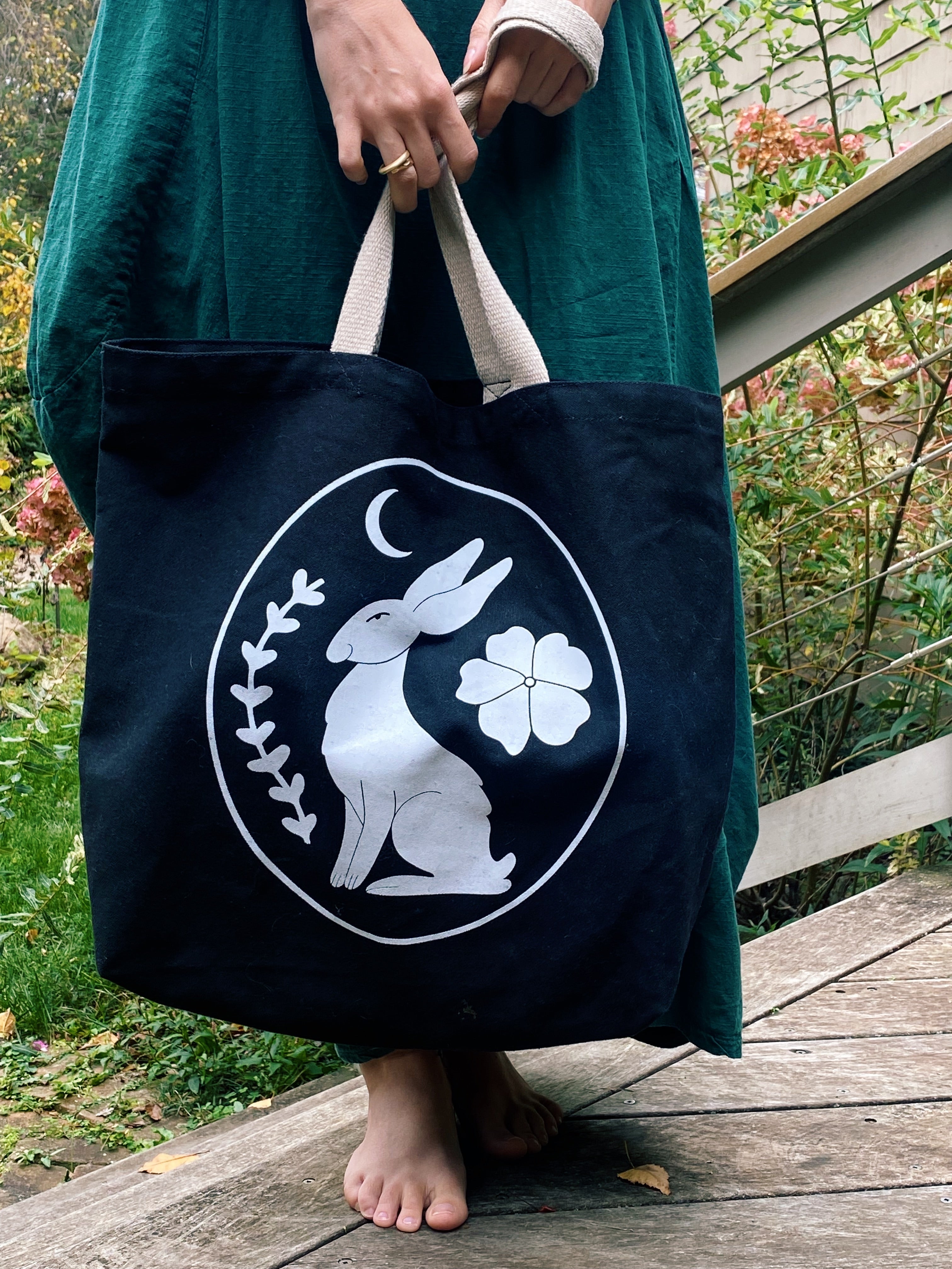 black canvas tote bag with rose and ravine logo